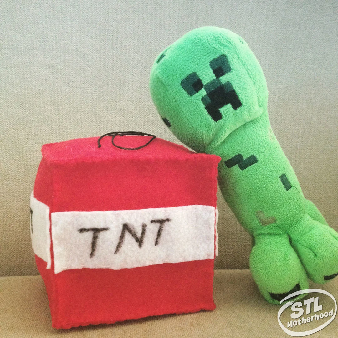 Toy creeper leaning on a handmade TNT plushy made of felt