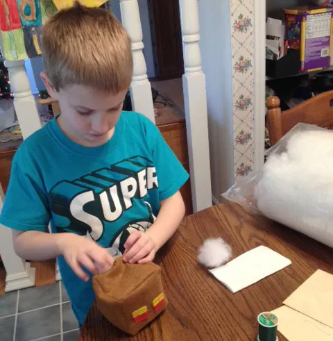 kid stuffing a Minecraft plush felt Magma cube