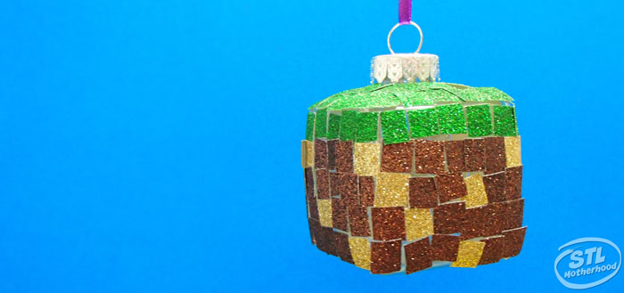 square ornament with green, gold and brown glitter stickers to look like a Minecraft grass block