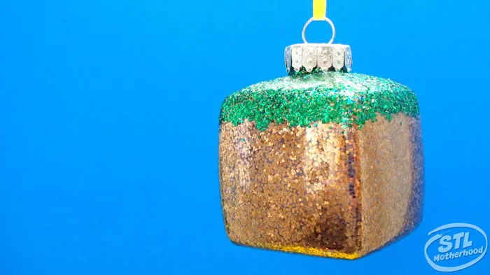 square ornament with Green and gold glitter to look like Minecraft grass block