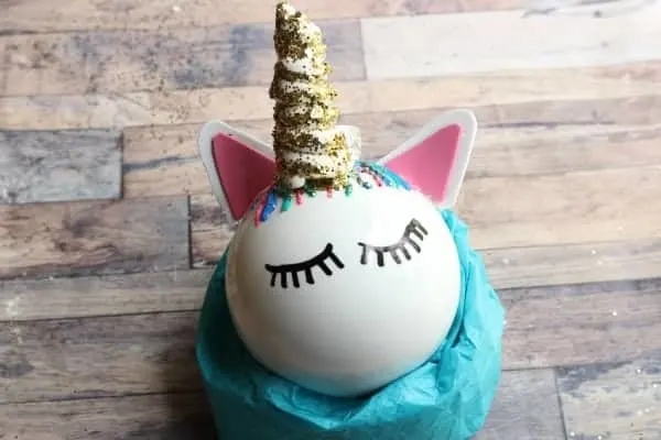 Unicorn Ornament--ball with closed eyes painted on, with ears made from foam and unicorn horn