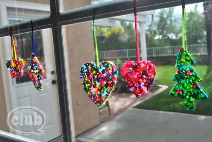 colorful melted bead ornaments hanging in window