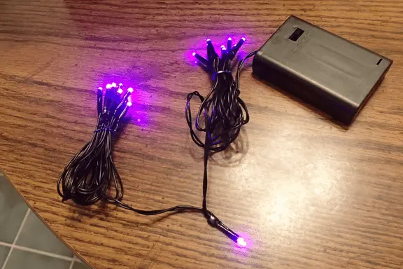 purple twinkle lights on a battery pack