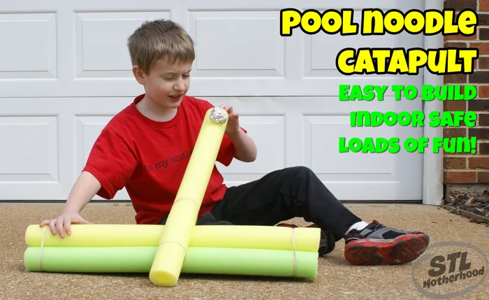 kid in red shirt with pool noodle catapult