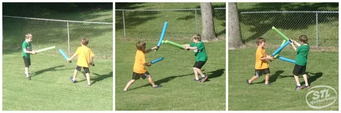 2 boys playing with Star Wars Light Sabers made from pool noodle on a green lawn
