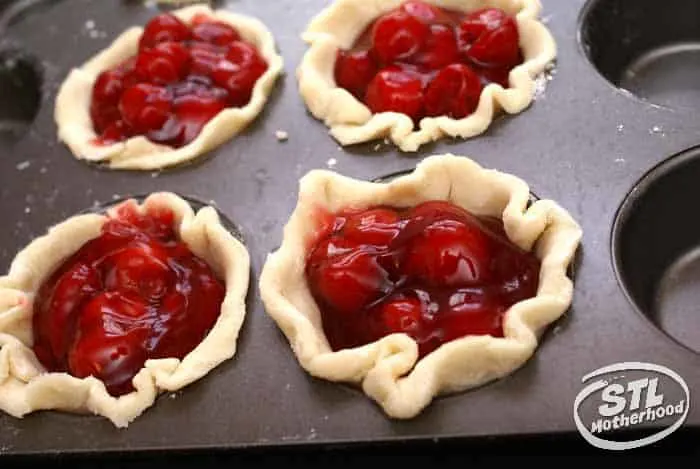 mini cherry pies in a cupcake tin