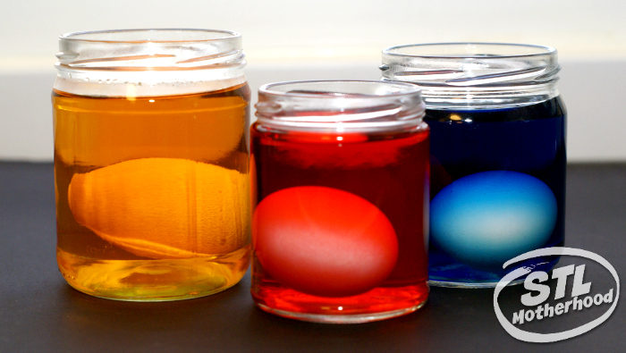 Eggs soaking in jars of vinegar easter egg dye