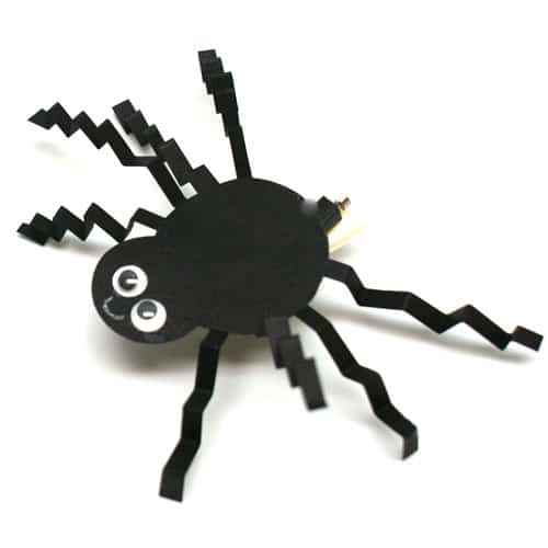 Halloween Brush Bot decorated with a paper spider and happy face.