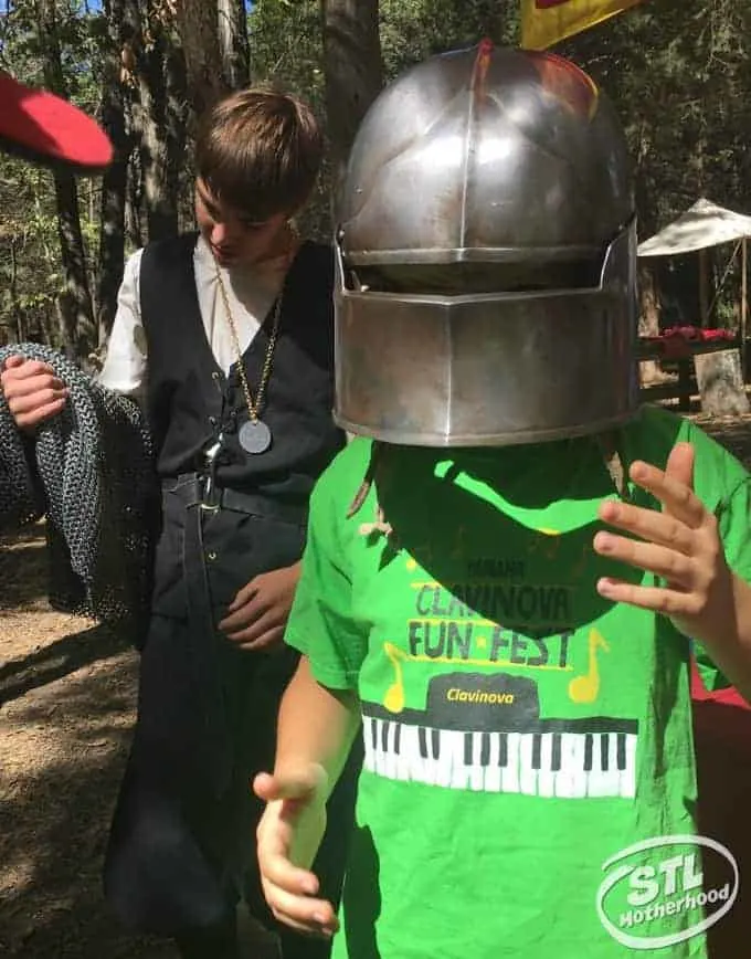 boy trying on some Renaissance Festival Armor