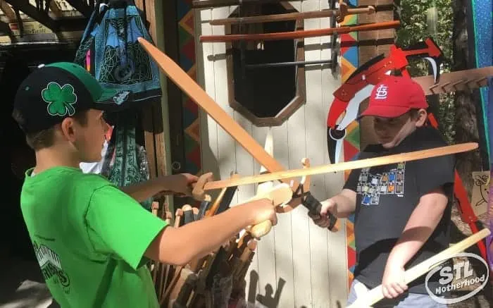 two boys shopping for swords at the St. Louis Renaissance festival