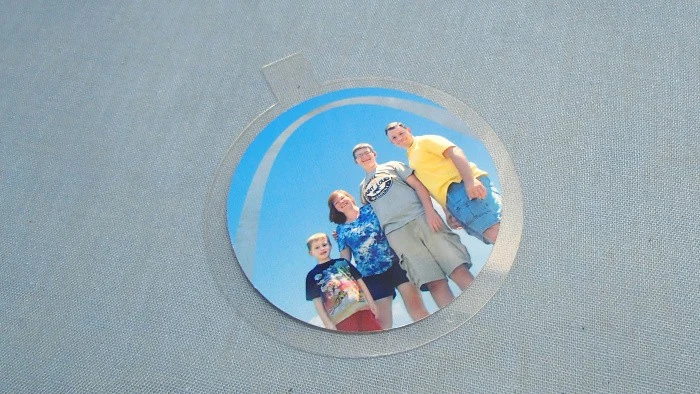 the secret to a floating photo ornament is the sheet of plastic inside