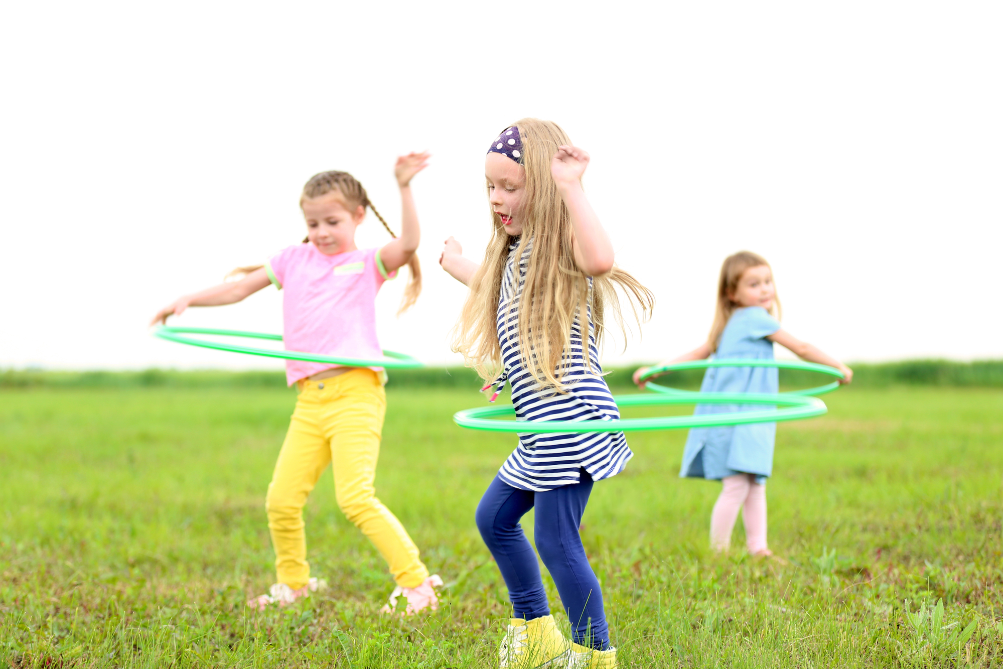 Children having fun with hula hoops outdoor