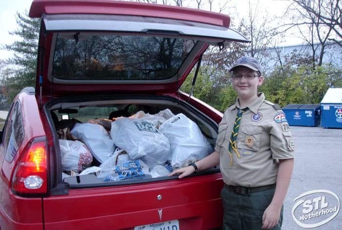 boy scout with car full of donations to Goodwill