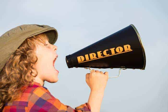 Kid shouting through vintage megaphone. Communication concept. Retro style