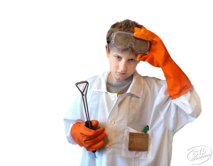 kid in mad scientist costume with goggles, rubber gloves and lab coat