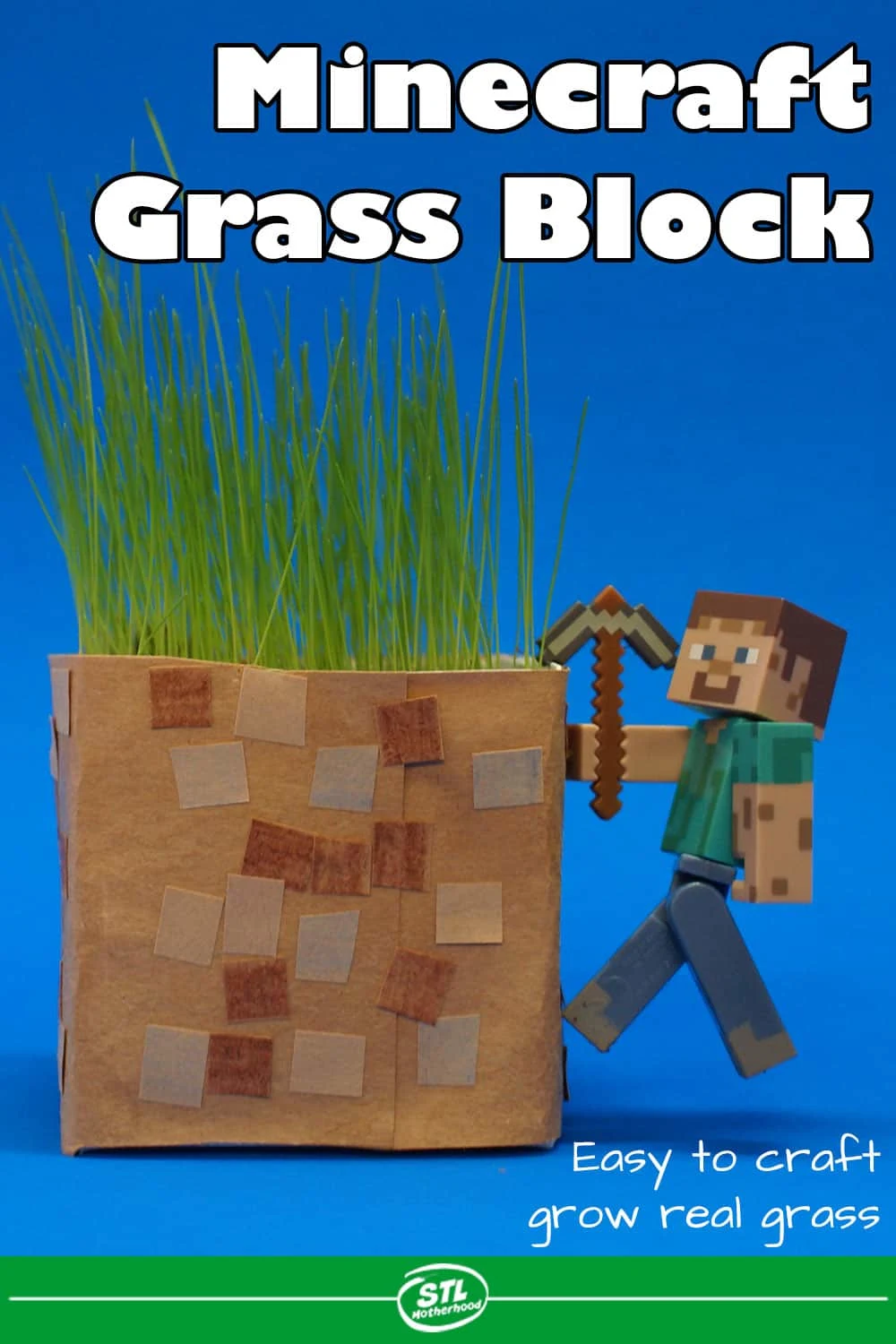 Minecraft block made from a dairy carton and decorated with paper, planted with grass.