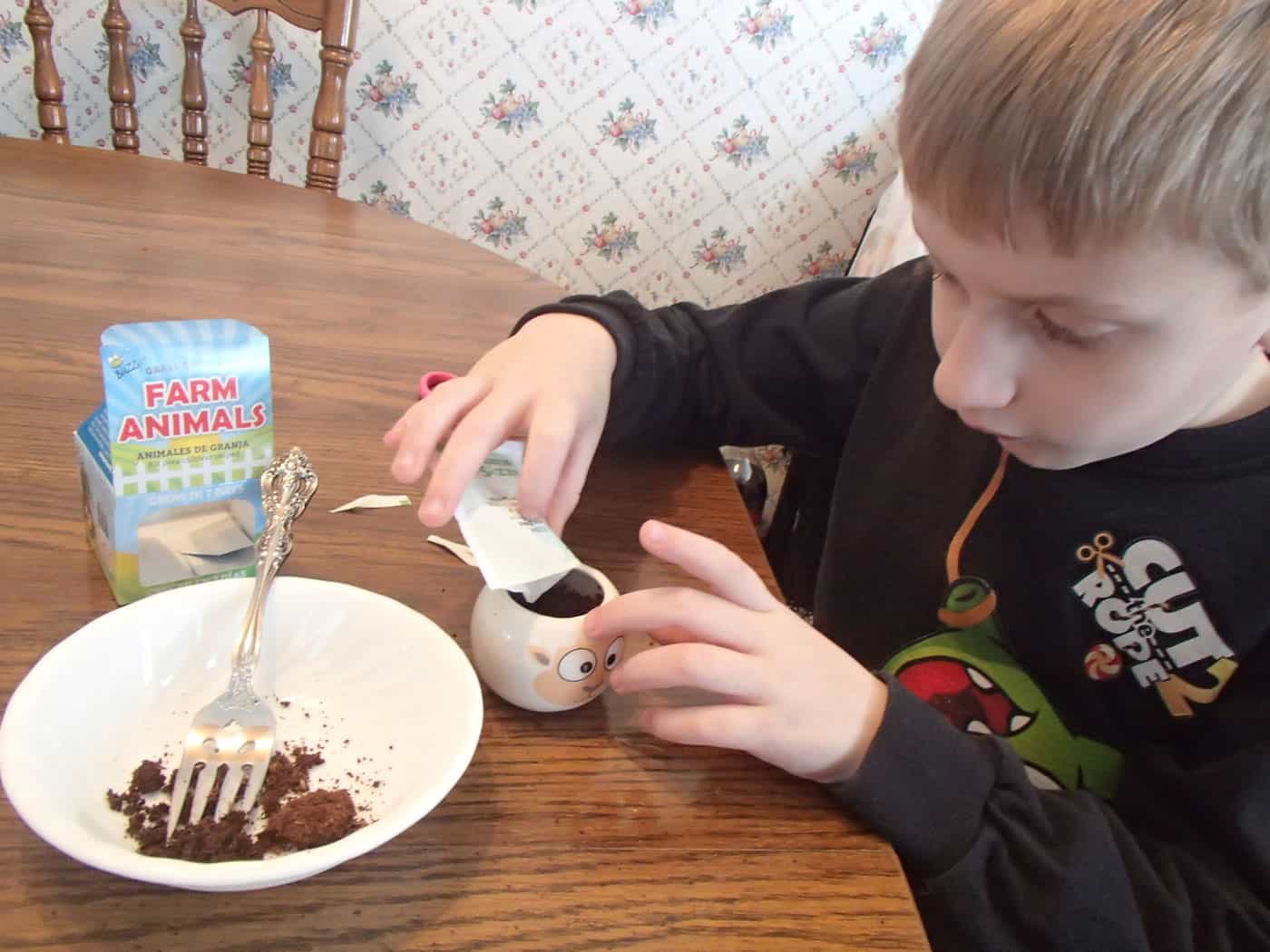 kid planting seeds in decorative planter