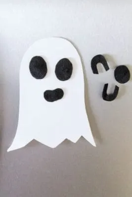 Halloween ghost magnet art stuck on fridge.