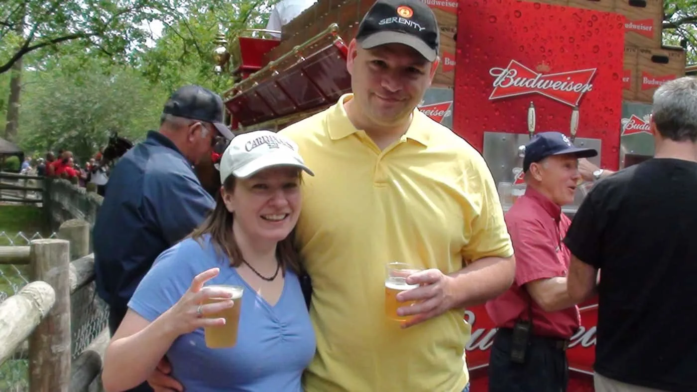 The blogger and her husband having a free beer from the Budweiser horse drawn wagon.