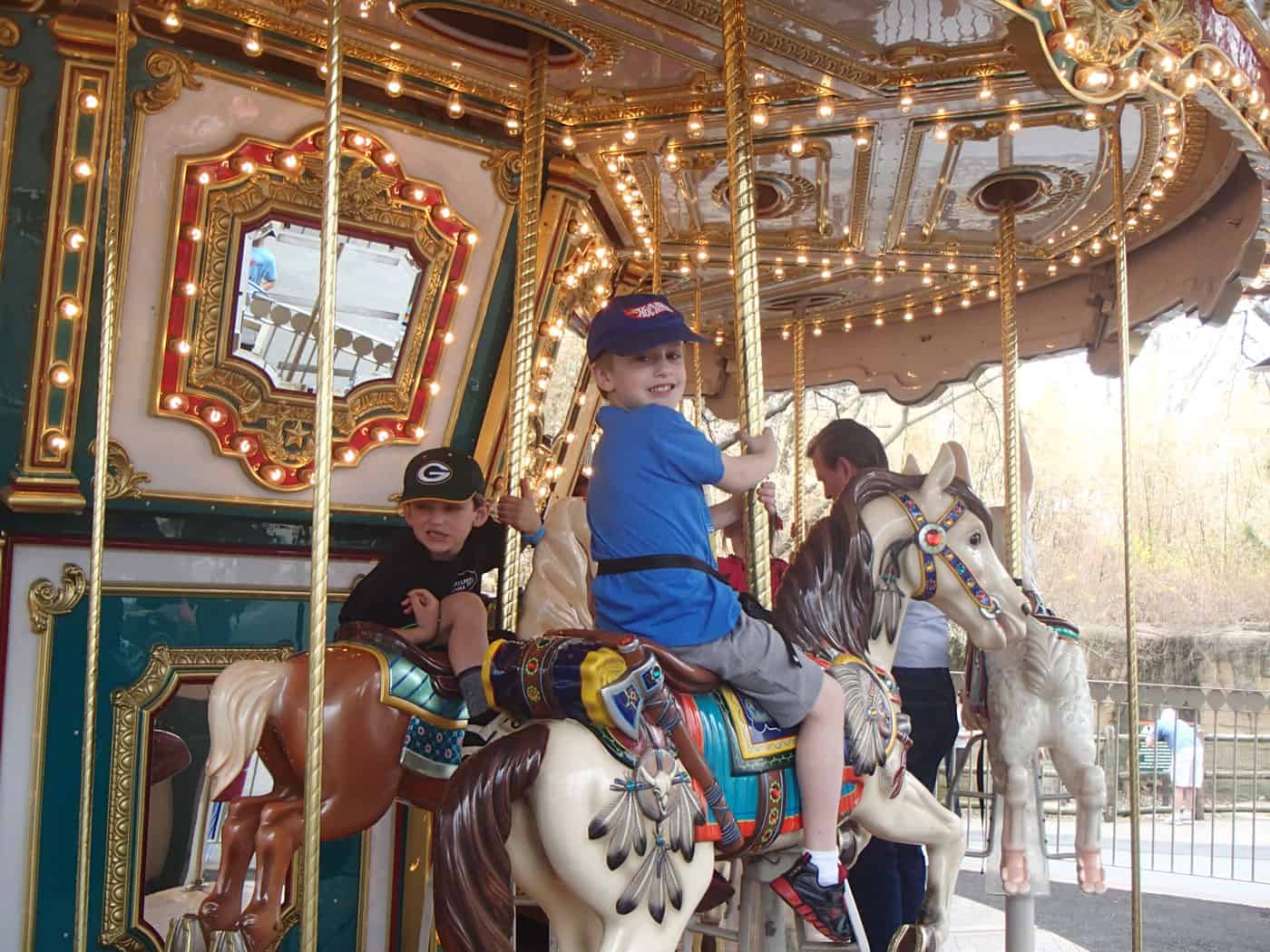 boys riding the carousel horses at Grant's Farm