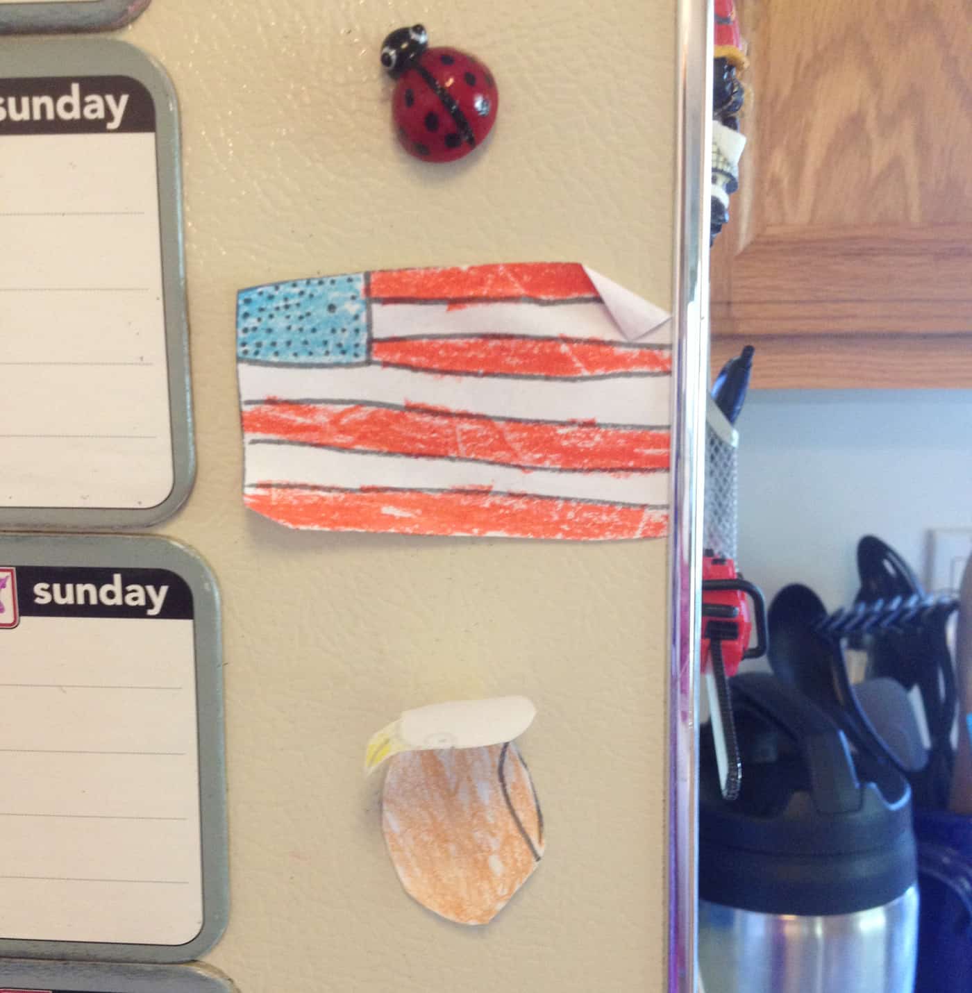 child's art taped to refrigerator getting crumpled with age