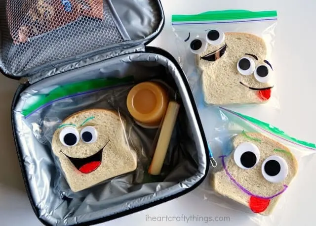 Lunch box holding sandwiches decorated with googly eyes