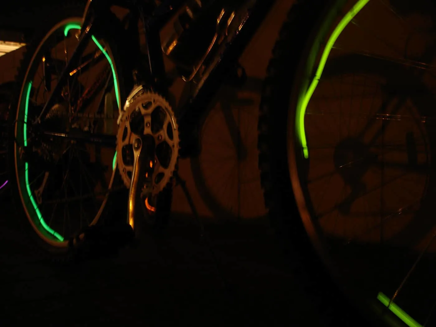 glow stick necklace wrapped around the spokes of a bike 