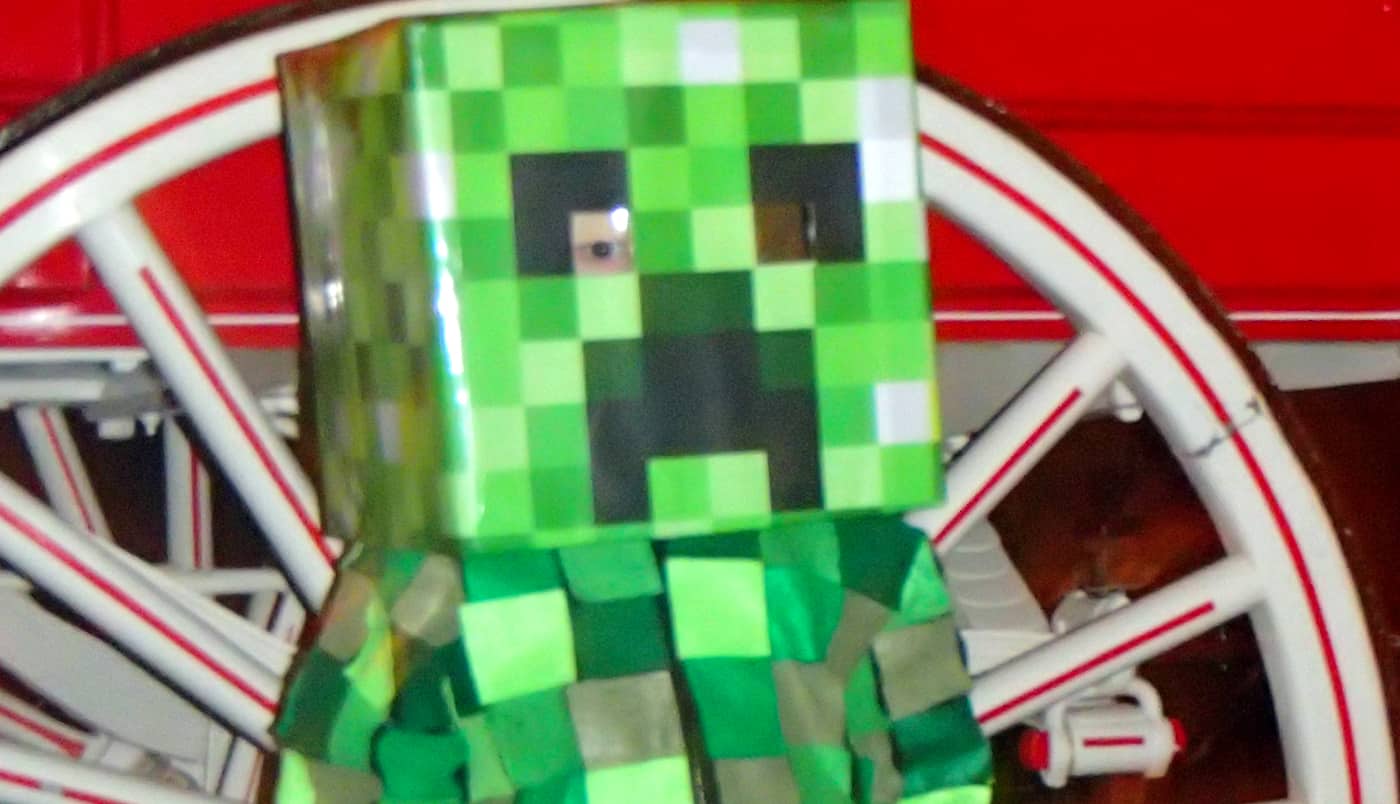 kid in a Halloween Minecraft creeper costume that is home made