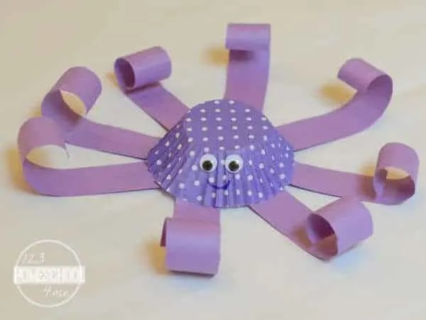 octopus made from paper strips and purple cupcake liner