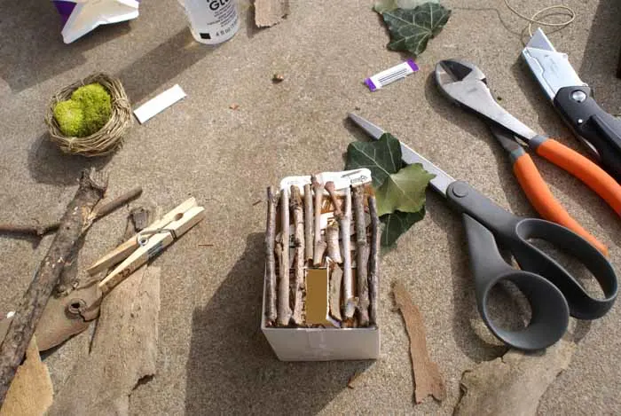 sticks on a dairy carton to build a fairy house