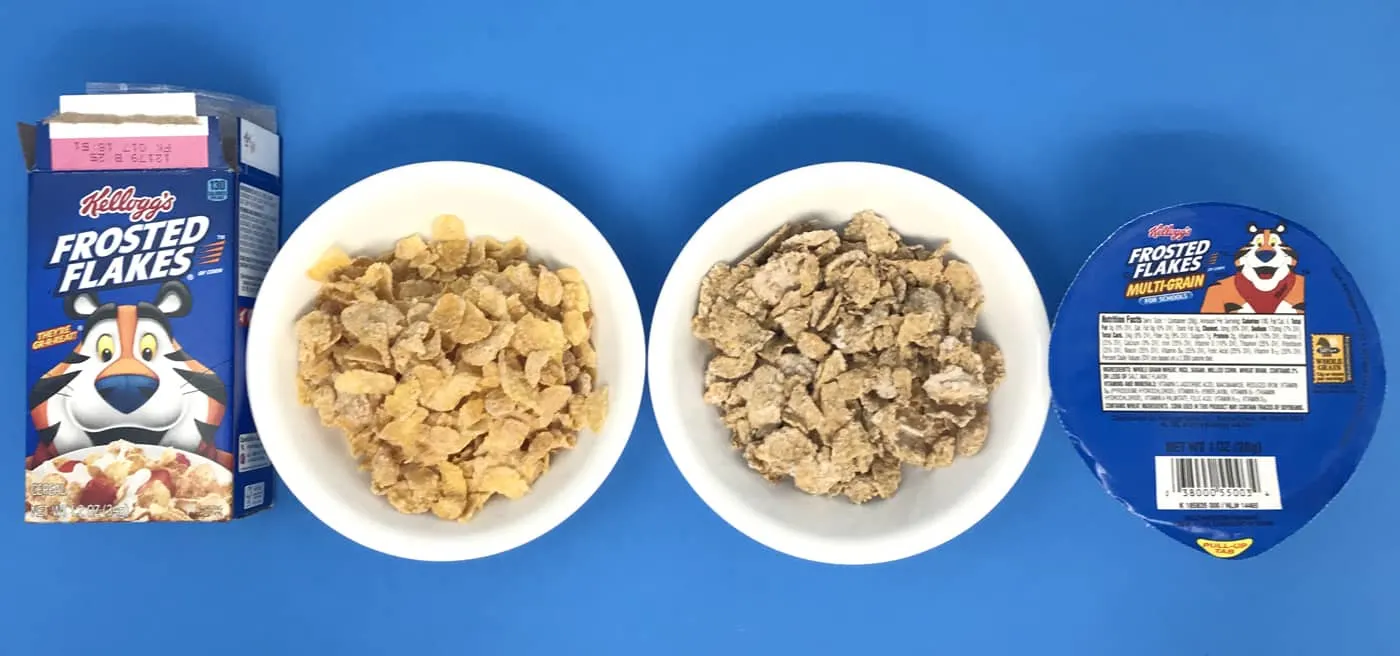 Two bowls of Frosted Flakes, one is whole grain for schools.