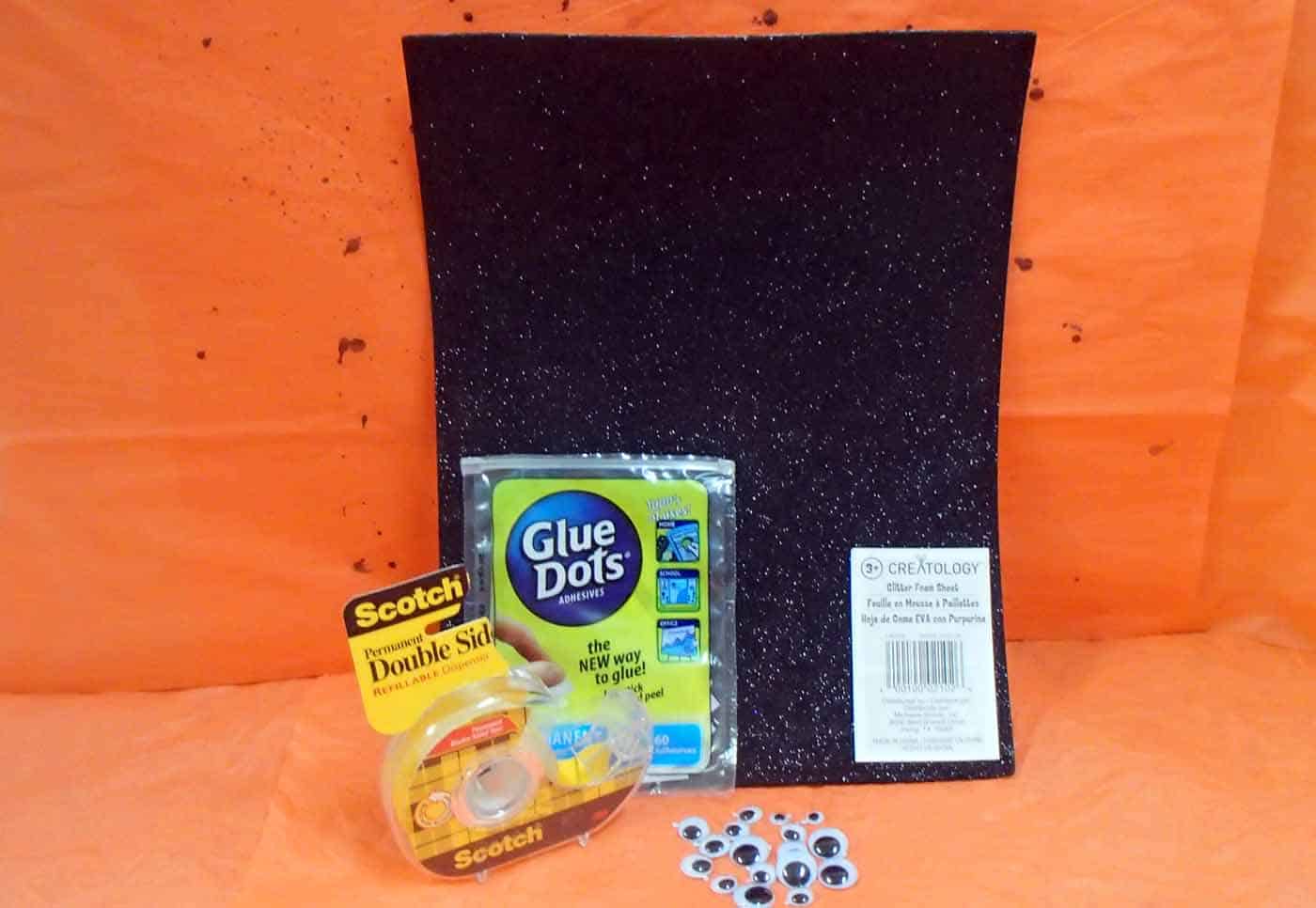 supplies for no carve pumpkin: black glitter foam, black paper, glue dots, double stick tape, googly eyes