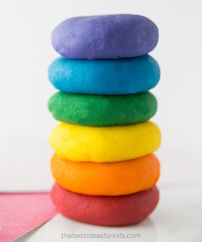 Stack of play dough balls in a rainbow of colors