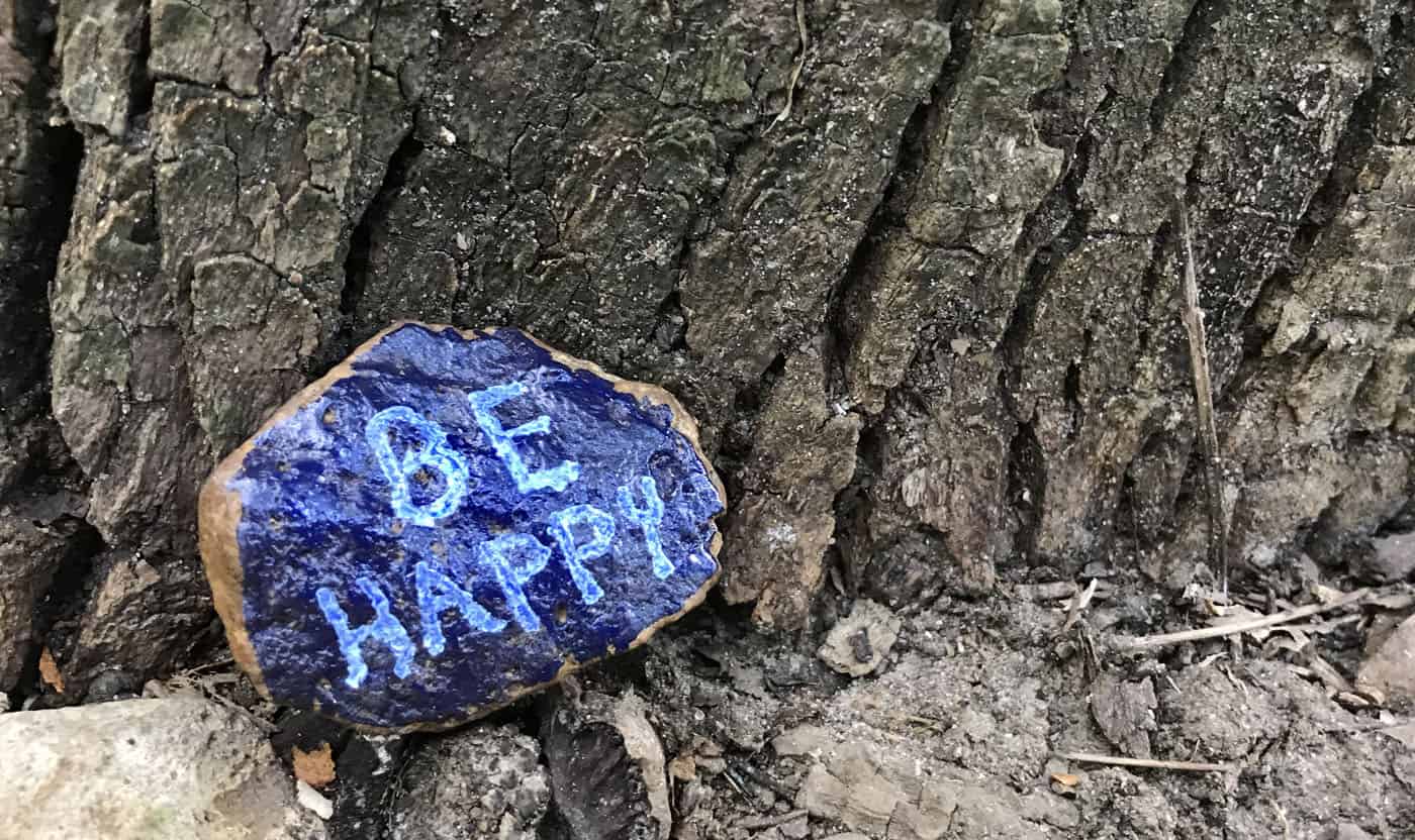 rock painted with "be happy"