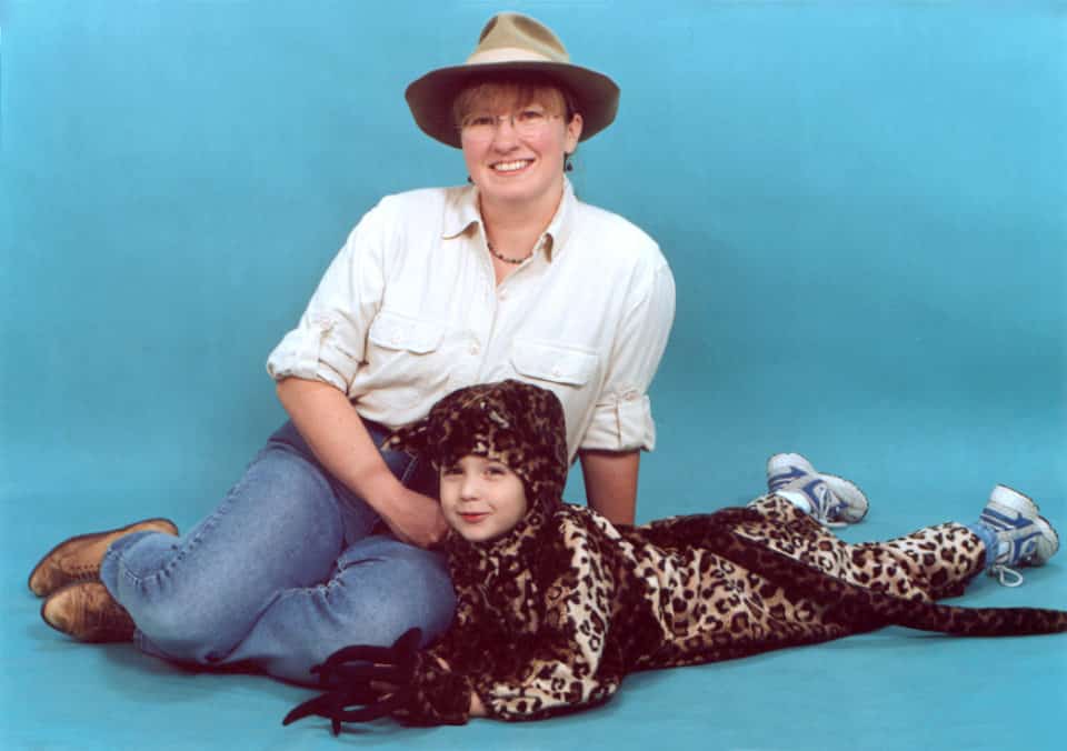 Mom and kid Halloween costume: kid in a spotted Jaguar costume, mom dressed as zoo keeper