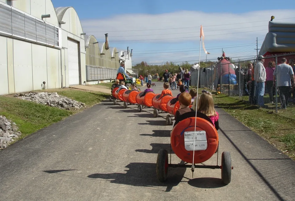 Kids riding a tractor pulled barrel train at Stuckmeyer Farm, a top St. Louis Pumpkin Patch