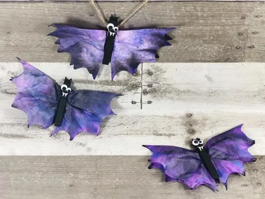 Purple and black bats made from coffee filters and clothes pins