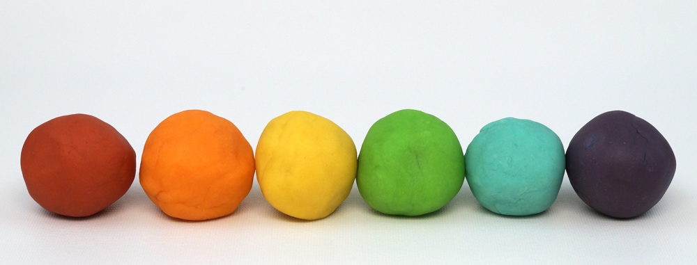 balls of home made play dough in rainbow colors