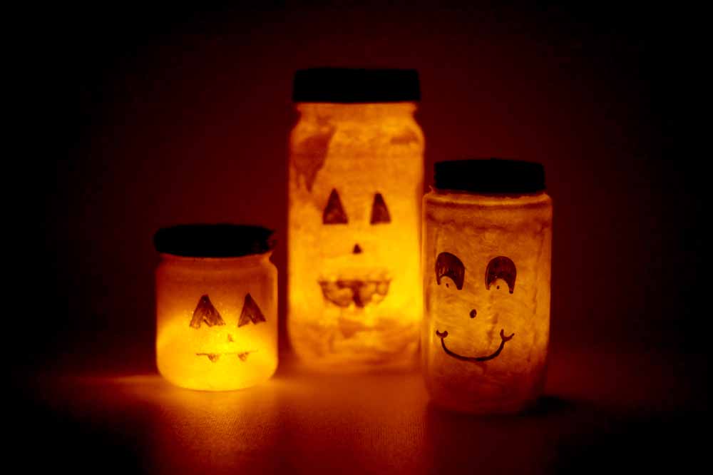 recycled jars, painted like pumpkins, lit with LED candles