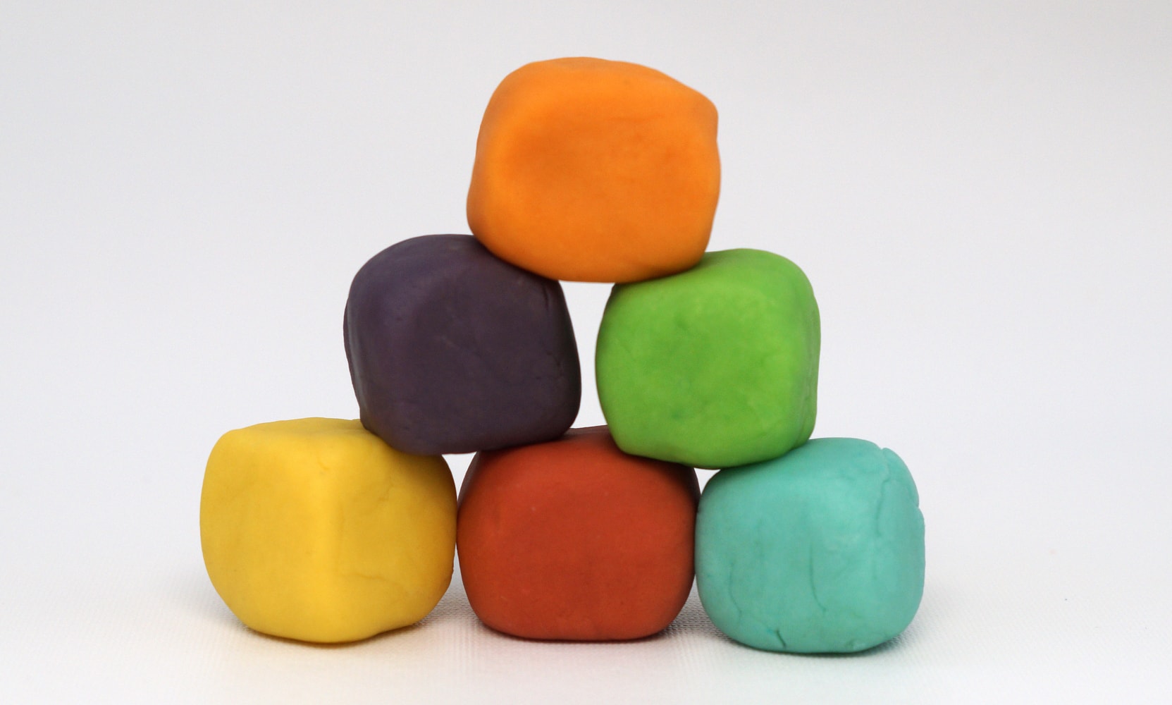 blocks of home made play dough in rainbow colors