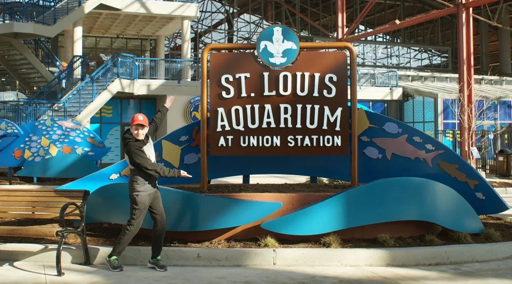 St. Louis Aquarium entrance with boy pointing at sign