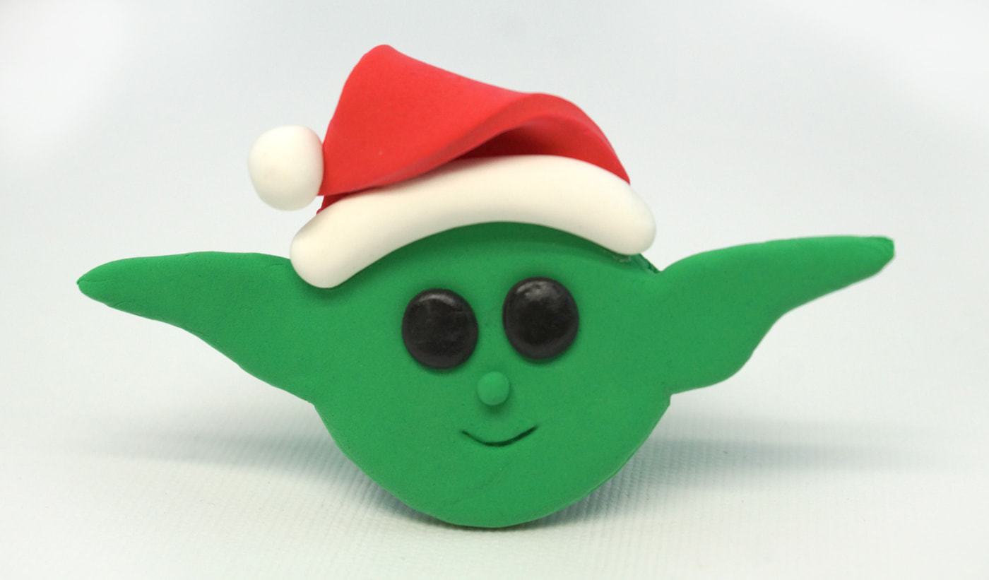 Baby Yoda Christmas Ornament made from green Model Magic and wearing a red Santa hat.