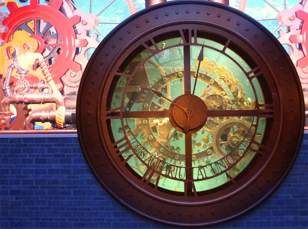 St. Louis Aquarium's clock tank filled with discus fish and a steam punk background