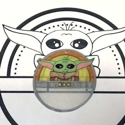 baby yoda shrinky dink shown next to drawing it was traced from