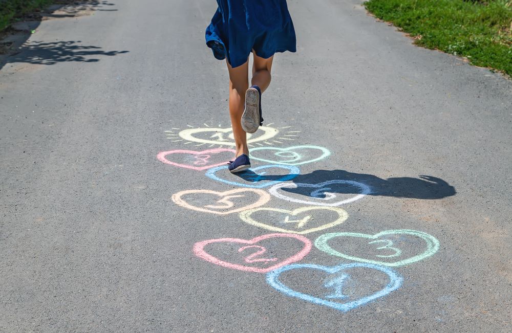 One Kid playing hopscotch