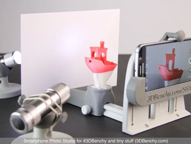 3D Printed studio for cataloging your fleet of Benchy Boats and other small things. Holds a smartphone, the Benchy, paper for a backdrop and two flashlights.