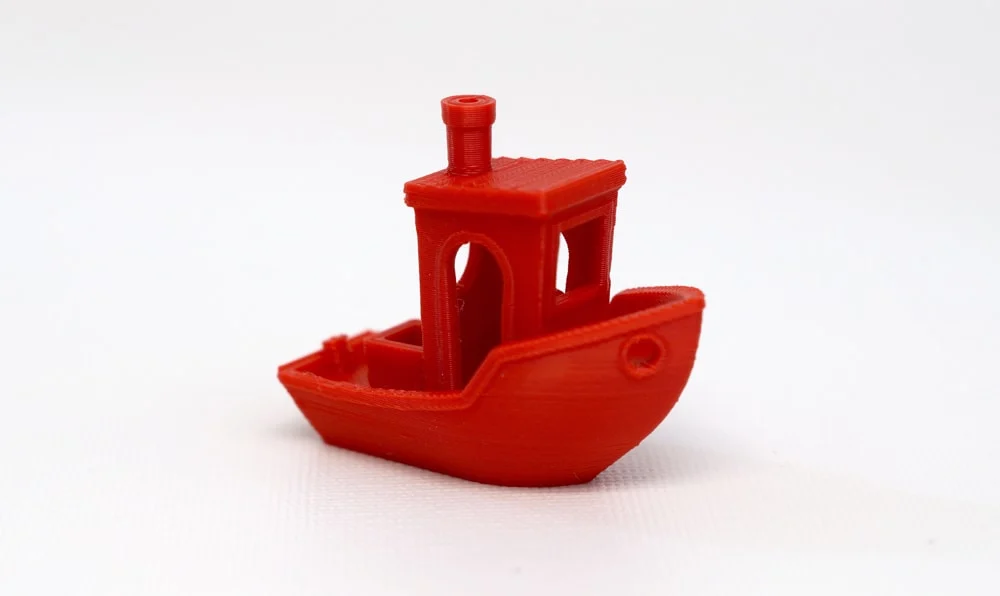 A red 3DBenchy bench marking boat 