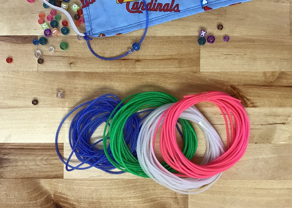 bunches of colorful plastic lacing to make face mask lanyards for kids