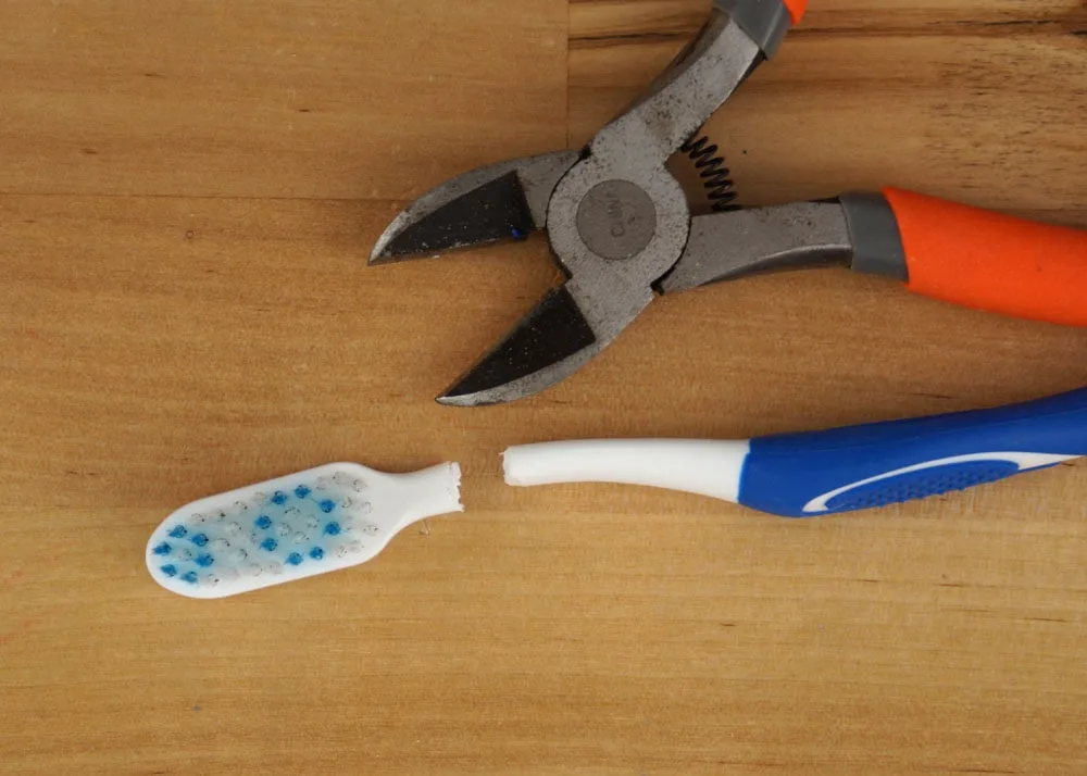 cutting the handle of a tooth brush off with snips