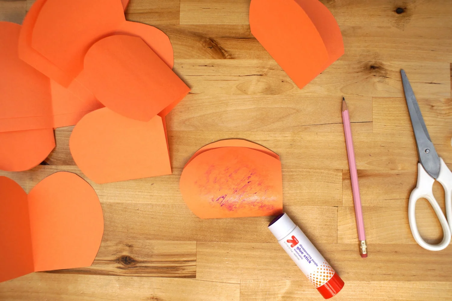 gluing paper pumpkin slices together